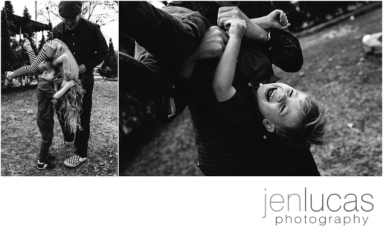 Black and white. Dad and two kids play in the backyard together. 