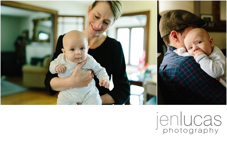 Mother holds baby in the kitchen; Dad holds baby on the couch. 
