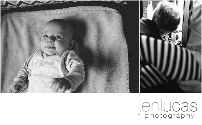 Black and white. Newborn baby boy makes eye contact wiht camera. 