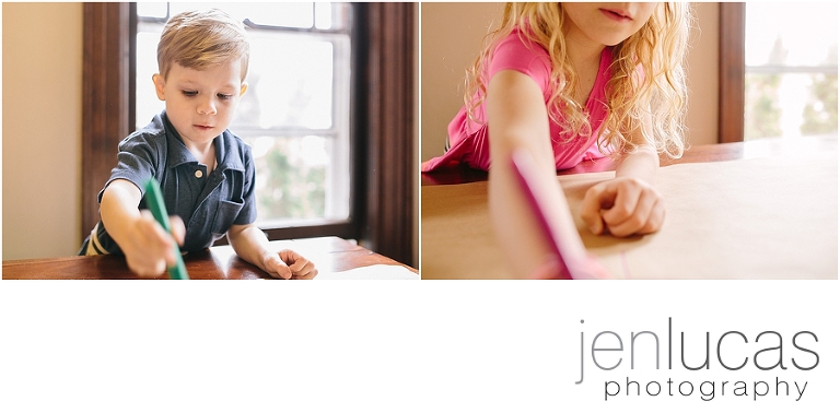 A boy, left, used a green marker to draw. Girl, right, starches out hand holding pink marker. Focus is on faces. 