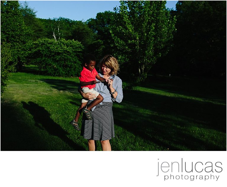 Mother holds son in the Arboretum as they explore his nature finds. 