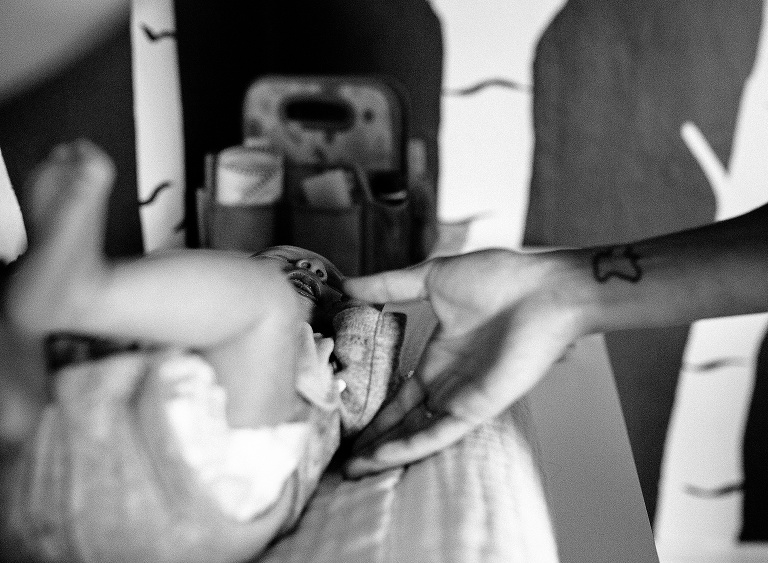 Black and white. Newborn baby laying on changing table.