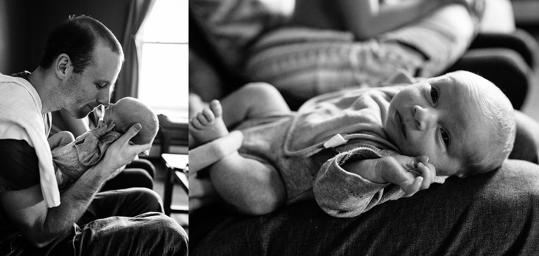 Black and white. Father holds up newborn baby to his face.