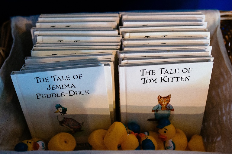 Many baby books laying in a basket.
