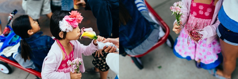 Sisters sit in a red wagon while at a farmers market.