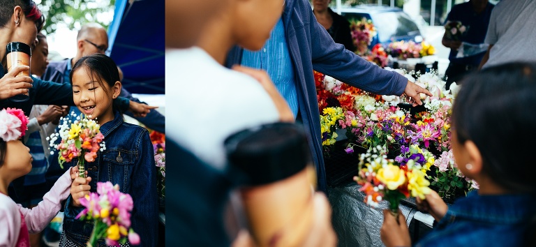 Family at a farmers market pick out a bouquet of flowers.