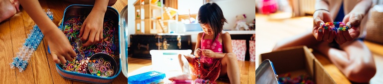 Sisters sit on the floor making bracelets together.