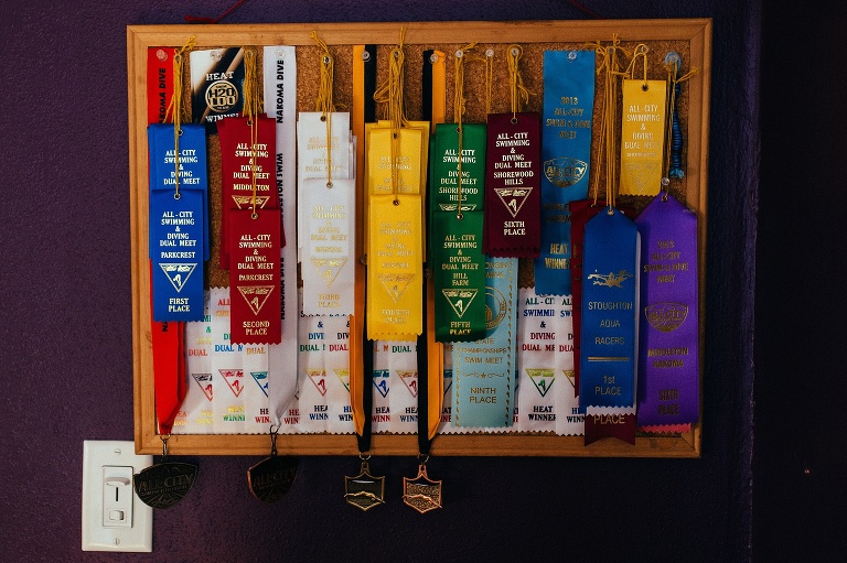 Many ribbons hung up on a cork board in kids bedroom.