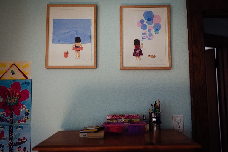 Two illustrations young up on the walls of kids bedroom.