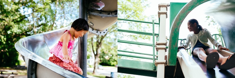 Sisters ride down a metal slide at a park playground.