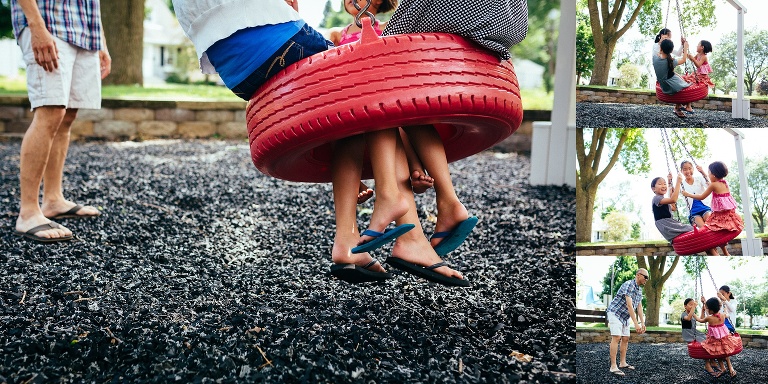 Three sisters al sit in a red tire swing together. all of them wearing flip flops.