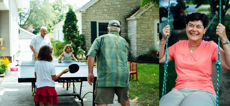 Family playing ping pong outside in the driveway. Mother swinging on a swing.