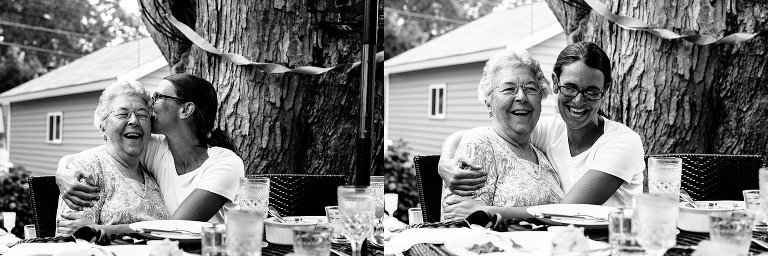 Black and white. Daughter hugs her mother celebrating her 90th birthday with a brunch with the family.