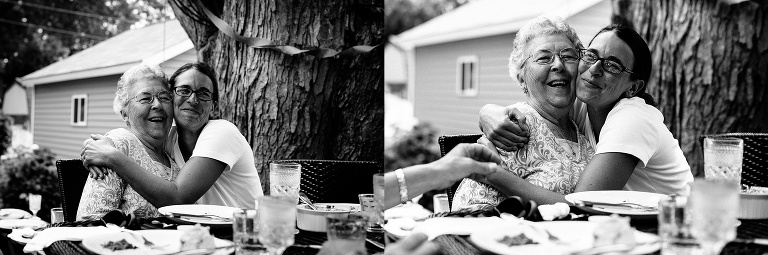 Black and white. Daughter hugs her mother celebrating her 90th birthday with a brunch with the family.