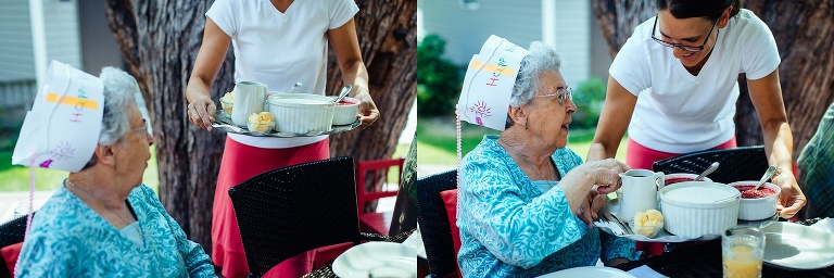 Daughter brings a tray full of brunch food out for her mothers 90th birthday celebration with the family.