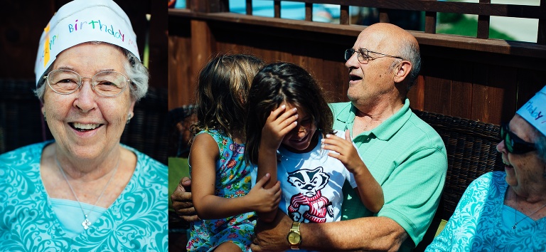 Family sits outside together grandmother wearing her happy birthday hat in celebration of her turning 90 years old.