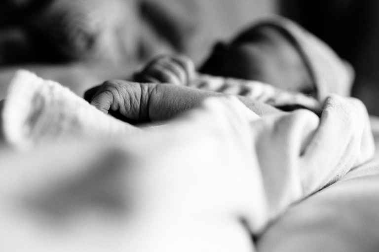 Black and white. Sleeping newborn baby's wrinkly arms