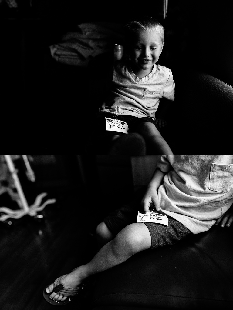 Black and white. Young boy sitting on a couch in the hospital room.