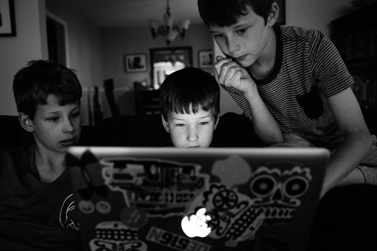 Three young boys explore on computer 