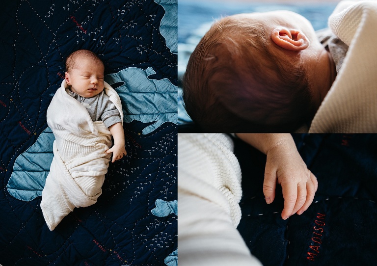 Sleeping newborn baby lays on blanket.
