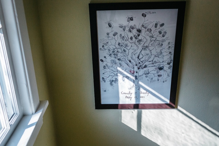 Family tree picture frame hangs on wall.