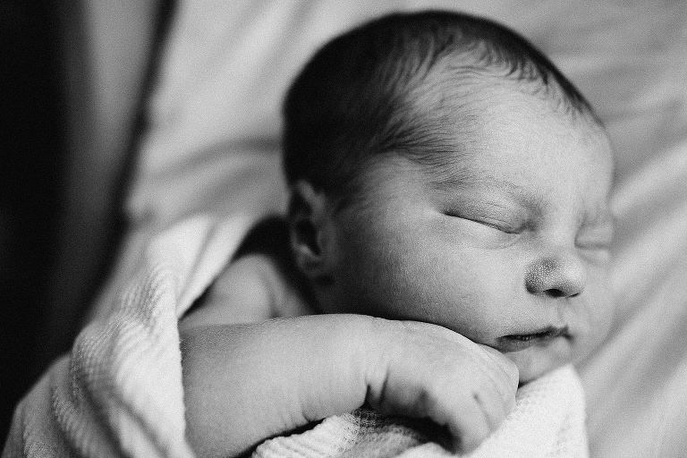 Black and white. Newborn sleeping baby swaddled in blanket.