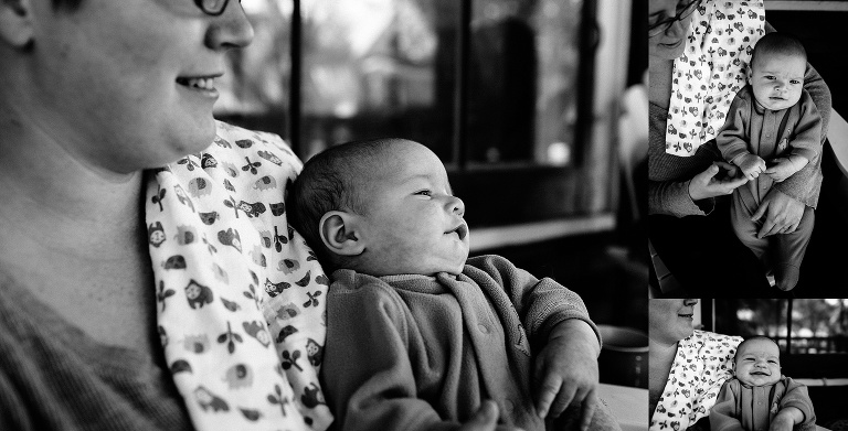 Black and white. Mother holds her newborn son while sitting on a backyard patio.