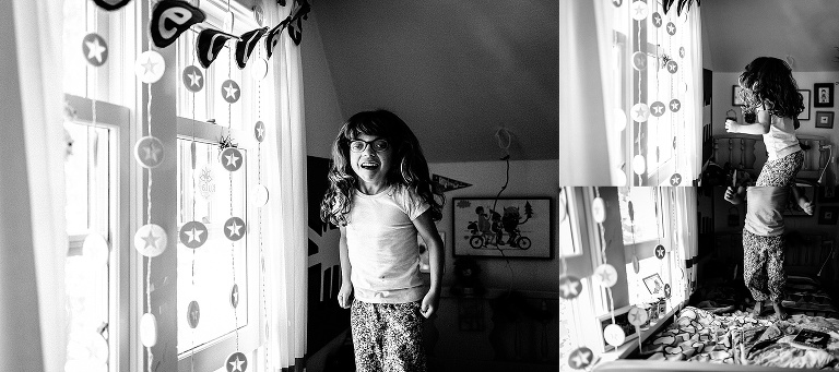 Black and white. Young girl jumps on her bed in her bedroom.