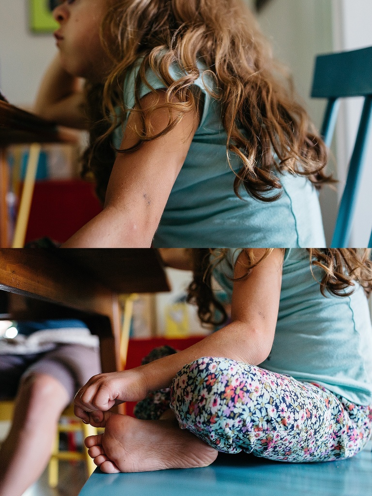 Young girl with curly brown hair sits at kitchen table eating breakfast.