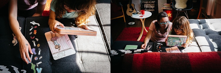 Mother and daughter play with a dress up book on the couch.