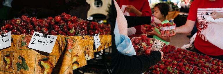Woman at a farmers market buys a container of strawberries.
