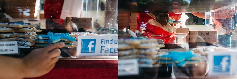 Girl at a cookie stand points to the blue star cookie she wants as the seller grabs it.