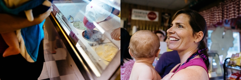 Mother holds son as she orders some ice cream at a ice cream shop.