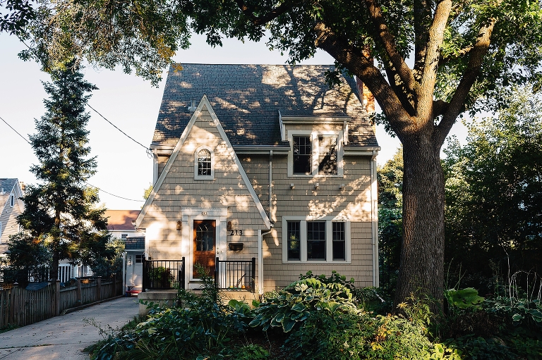 Cute house with shadows from a big tree on it.