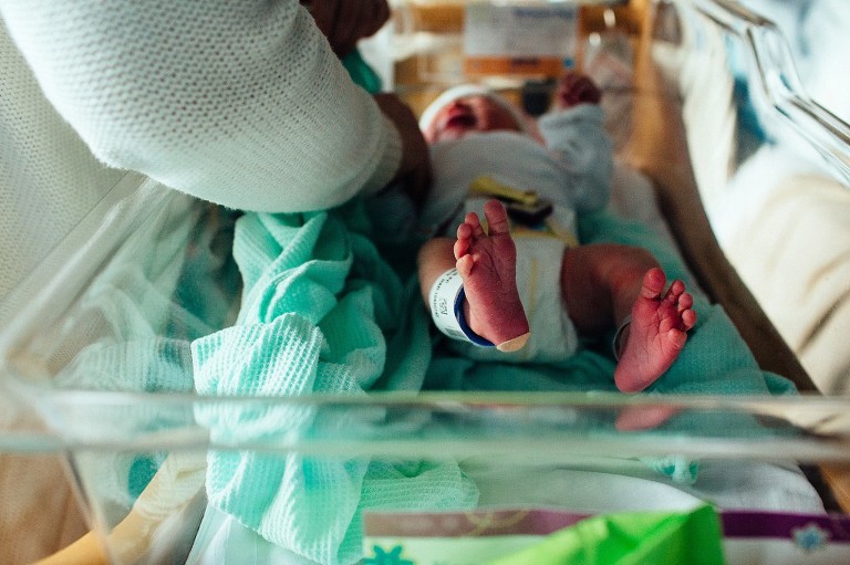 Newborn feet in a hospital isolet 