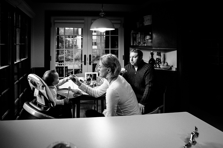 Black and white, Mother hands daughter food at dinner table