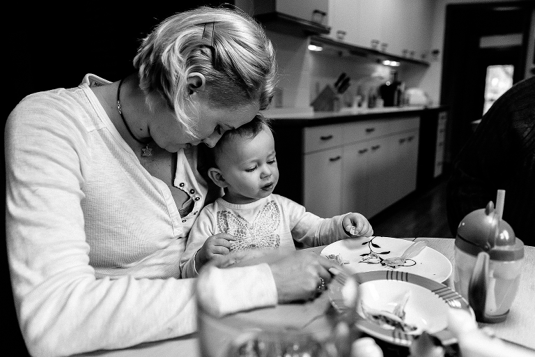black and white, Mother snuggle daughter at the dinning table while eating dinner