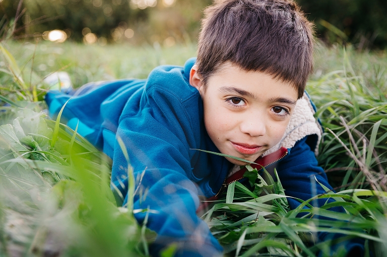 Boy lays in grass