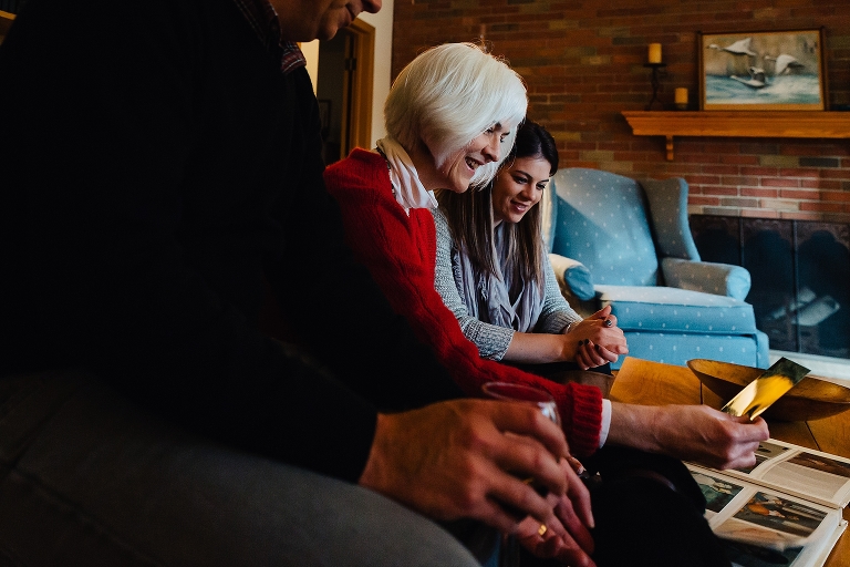 Family looks at old picture books together