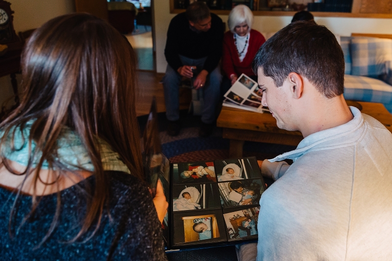 Family looks at old picture books together