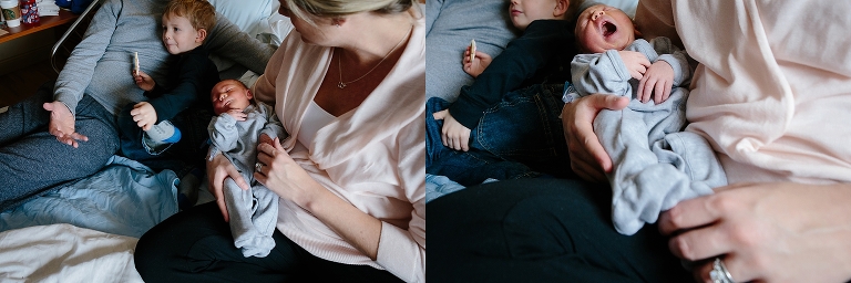 Family sits on hospital bed with crying newborn baby