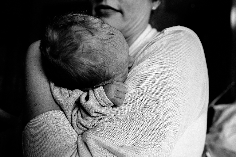 Black and white, Mother holds newborn baby in hospital. 