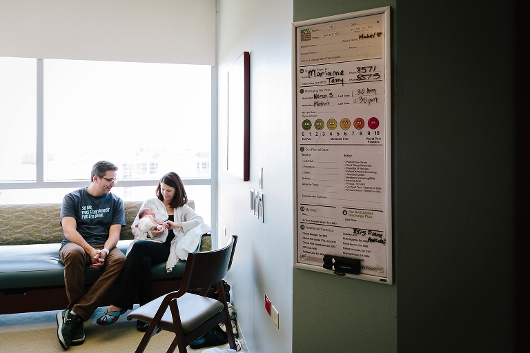 Mother and father watch their sleeping baby boy