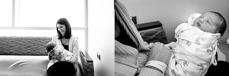 Black and white. Mother holds and smiles at newborn baby in hospital.