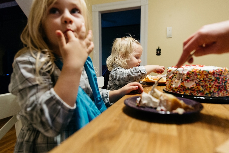 Two little girls eat birthday cake
