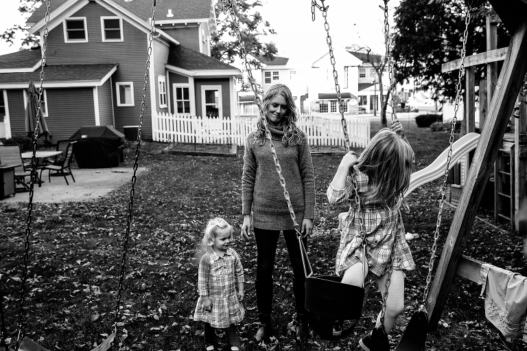 Black and white, Mother pushed daughter on the swing in their backyard