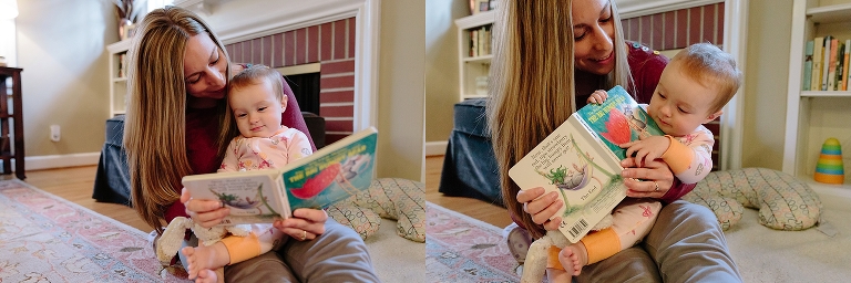 Mother reads to 6month old daughter on her lap. 