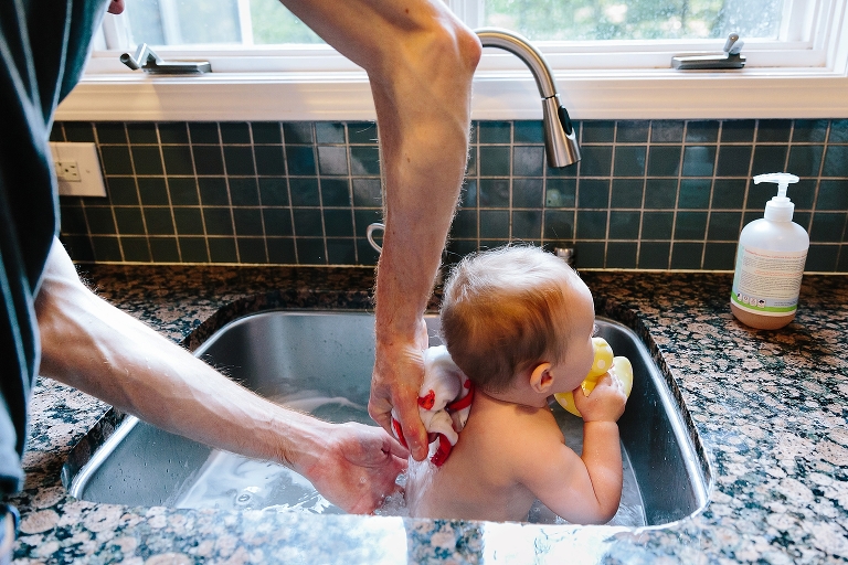 Dad washes daughter's back in sink bath