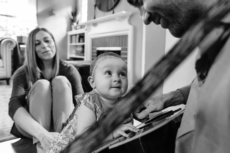 Baby gets close to dad playing guitar during a Sunday morning pancakes photo session