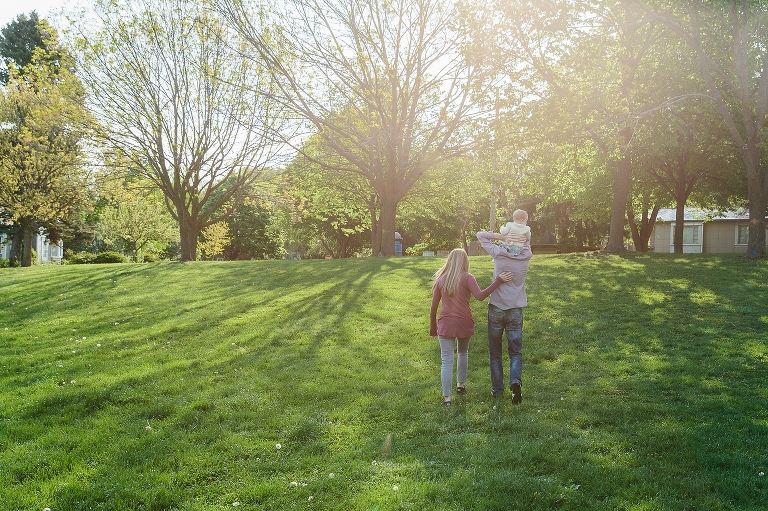 Back view of family walking back home. Shadow of tree as a sun rises. Heading back home to a Sunday morning pancakes photo session